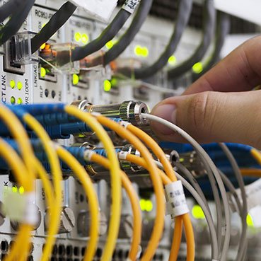 managed services person working with it networking cables
